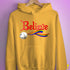 Believe LGBTQ Rainbow Pride Jingle Bell Hoodie - Mustard